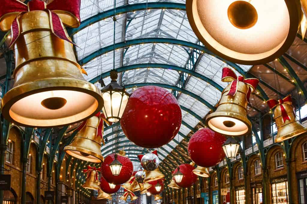 Hanging festive lights and baubles in a covered Christmas market